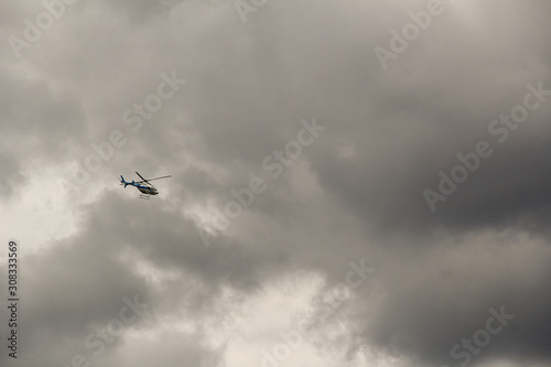 Helicopter in the clouds. Quickly climbs