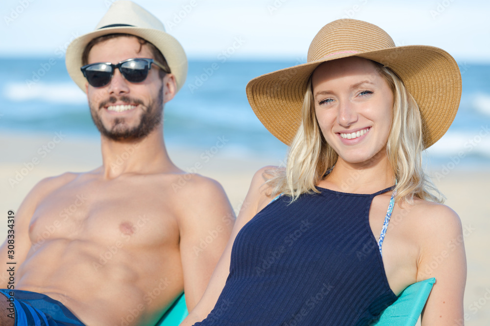 couple on the beach sunbathing