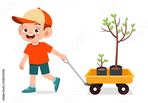 happy cute kid boy pull wagon with tree photo