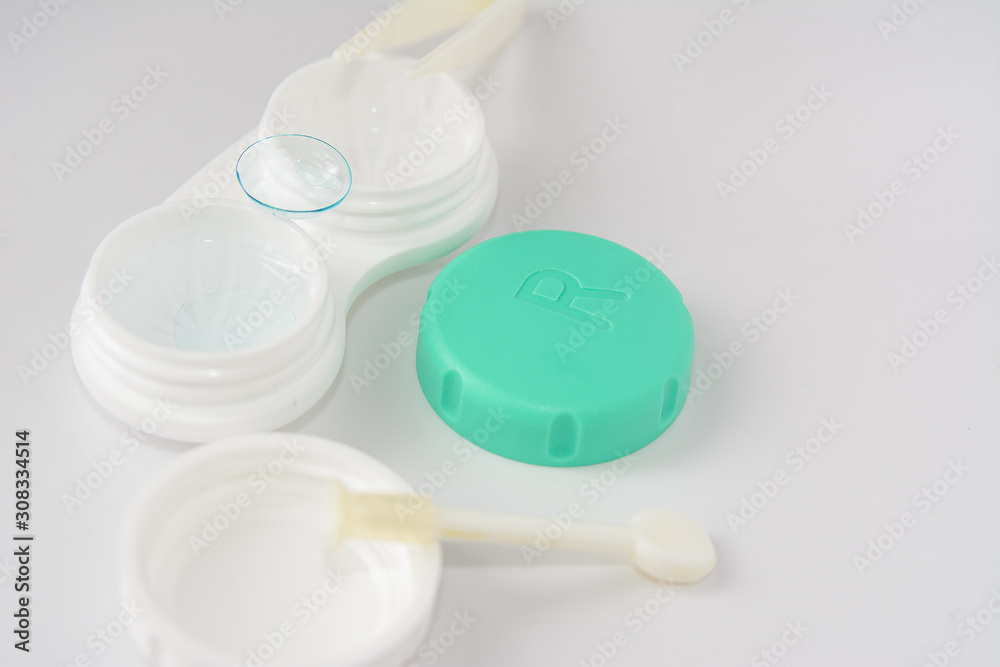 container for soft contact lenses and lens on light background, the concept of care for contact lenses container for soft contact lenses and lens on light background, the concept of care for contact lenses