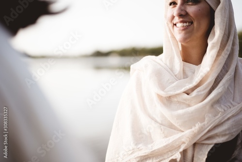 Fototapeta Shallow focus shot of a female wearing a biblical robe while talking to Jesus Ch