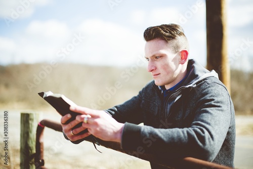 Shallow focus shot of a male reading the bible