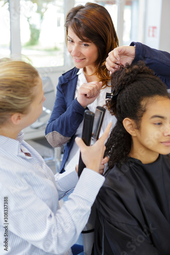 teacher talking to students while hairdresser test
