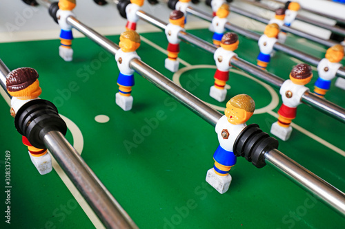 dolls of a retro foosball table to play table football