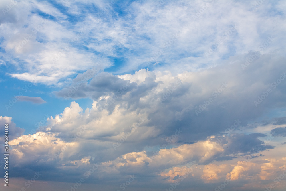 Obraz premium the sun shining through the clouds against the blue sky, light clouds in the sky