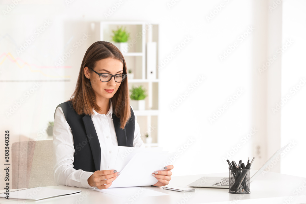 Beautiful young businesswoman working in modern office Beautiful young businesswoman working in modern office