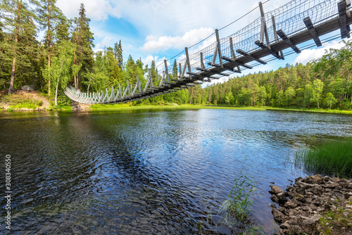 Fototapeta Naklejka Na Ścianę i Meble -  Suspended bridge through Yattumutka river in Oulanka National Park. Pieni Karhunkierros Trail in in Finland.
