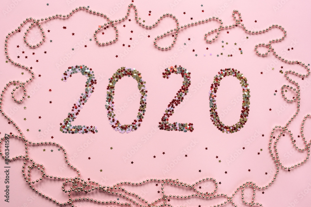Numbers 2020 made of confetti on pink background. Christmas or New Year layout, flat lay, top view.