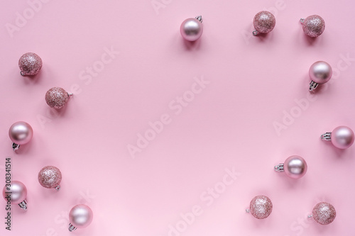 Christmas tree toys, flat lay. Festive New Year layout on pink background, top view, copy space.