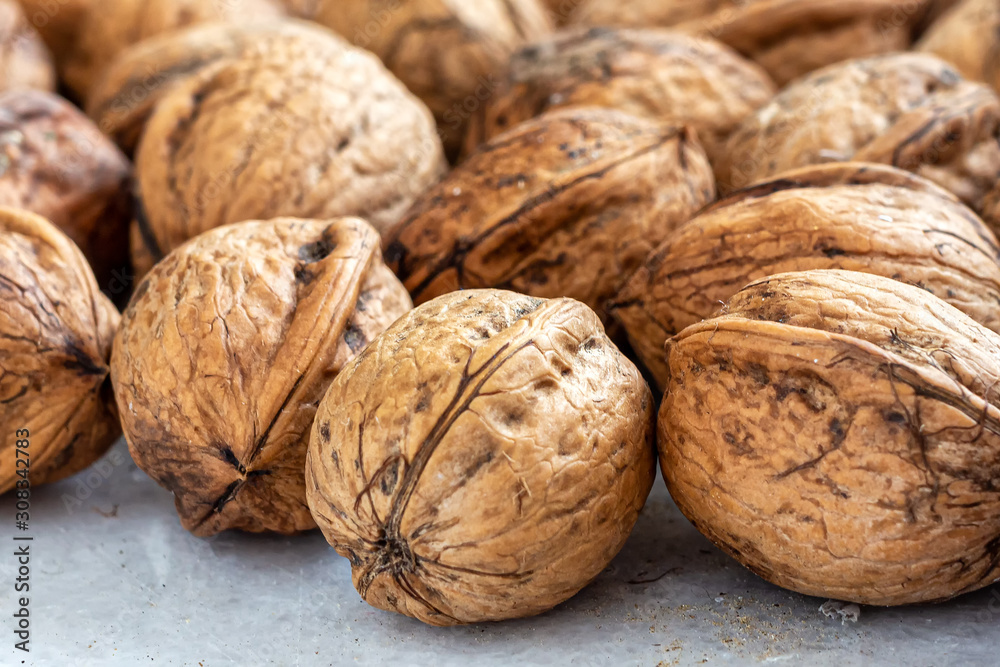 Walnuts with thick textured shells on the table Walnuts with thick textured shells on the table