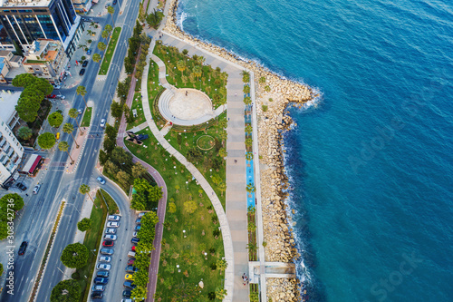 Limassol, Cyprus, aerial view at promenade or embankment. Famous Limassol walking alley with palms in resort town, drone photo. photo