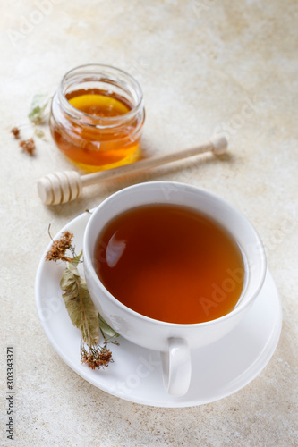 Cup of of tea with honey and teapot