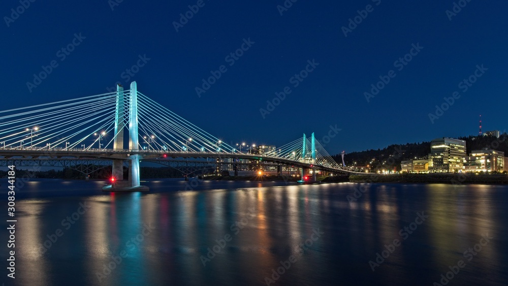 Tilikum Crossing Bridge of the People at night with lights reflecting on water Portland, Oregon