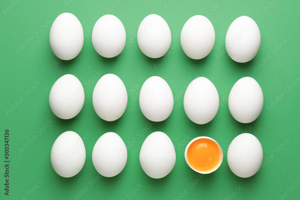 Broken egg among whole ones on color background. Concept of uniqueness Broken egg among whole ones on color background. Concept of uniqueness