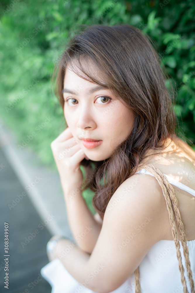 Beautiful wellness asian women walking in city park with white dress Beautiful wellness asian women walking in city park with white dress
