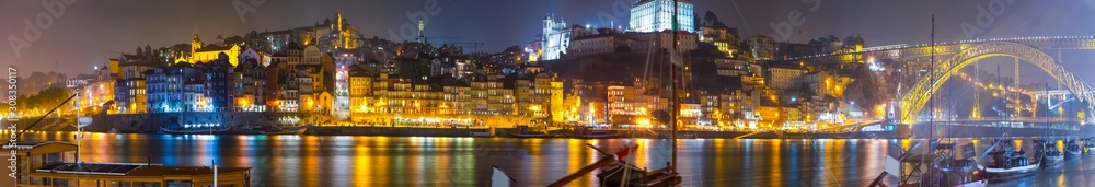 Amazing Travel Places. Beautiful Porto City In Portugal at Twilight with Line of Boats in Foreground.