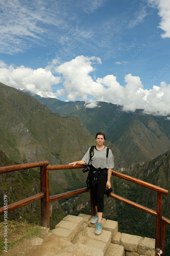 Brunette overlooking Andes Mountains at Machu Picchu