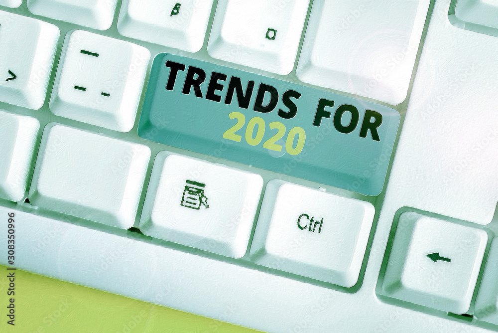 Text sign showing Trends For 2020. Business photo text list of things that got popular very quickly in this year White pc keyboard with empty note paper above white background key copy space