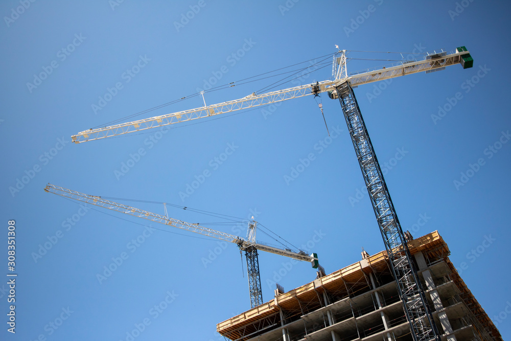 Cranes atop a tall building
