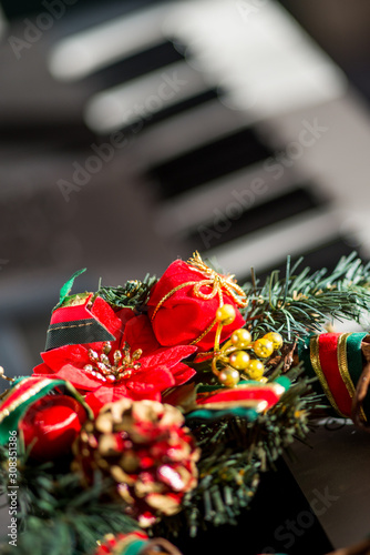Colorful christmas decorations attached to an elecric guitar.