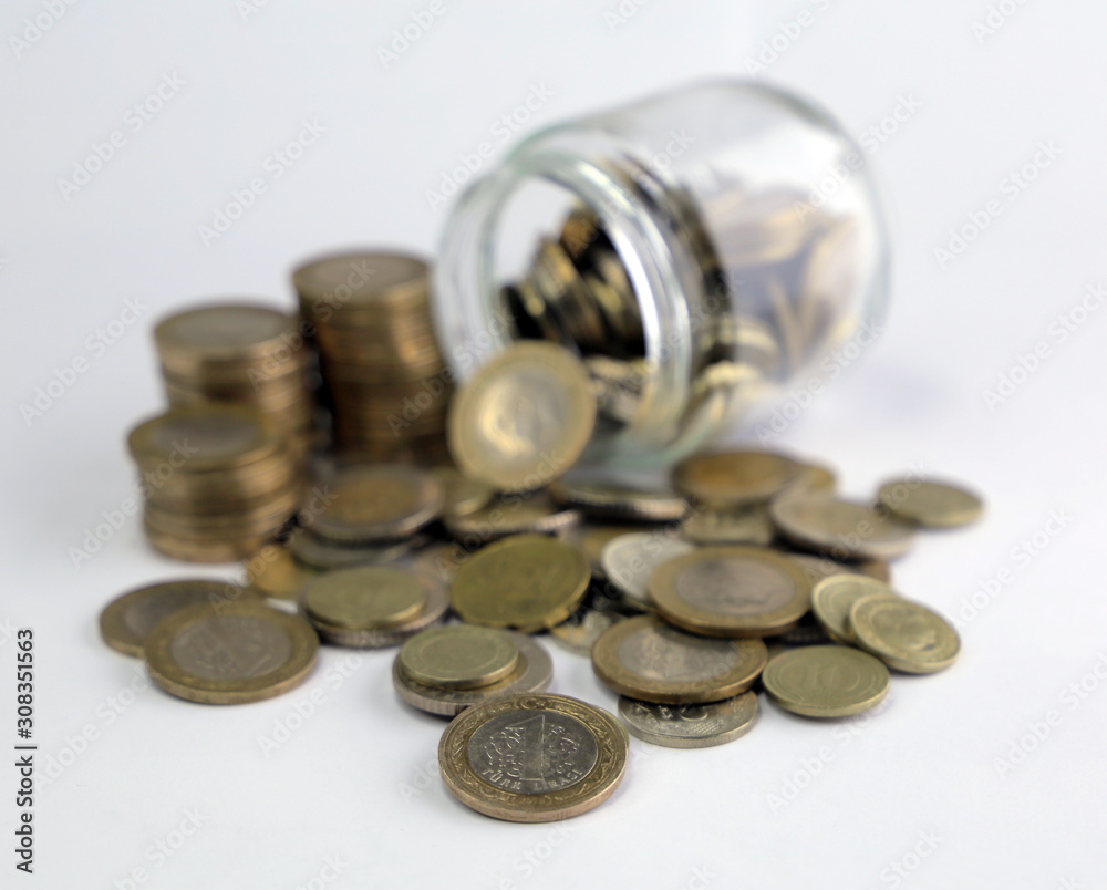 Rising coins, magnifying glass, Pile of mixed iron money coins background Rising coins, magnifying glass, Pile of mixed iron money coins background