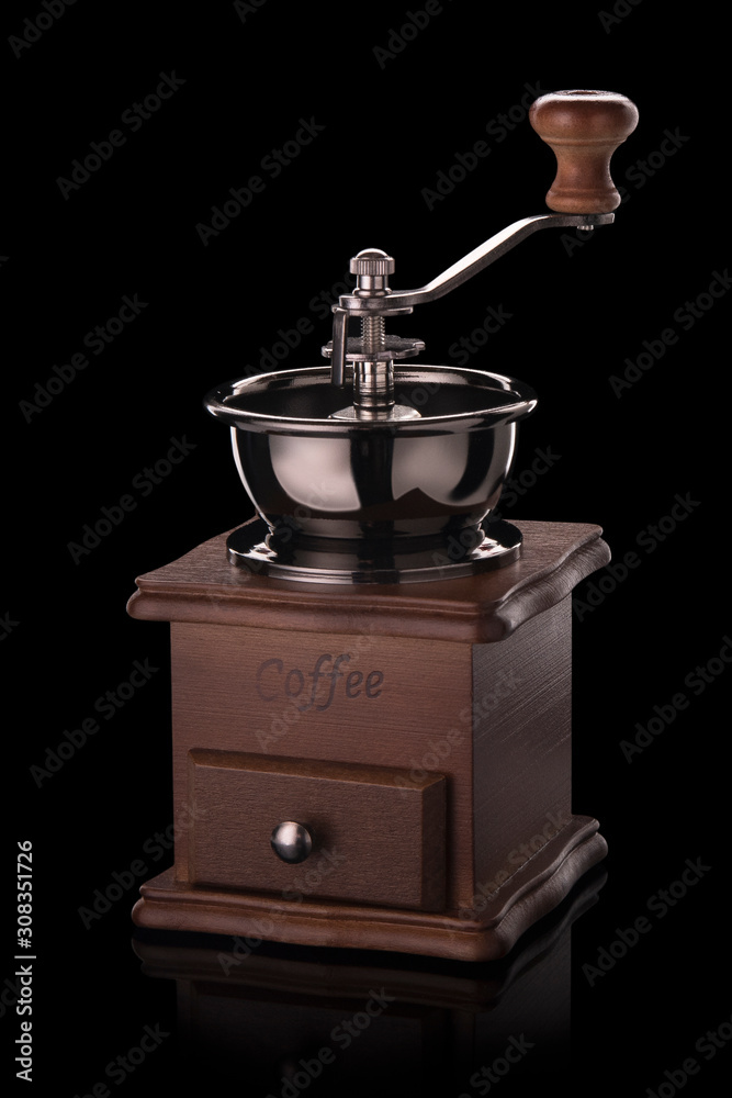 Coffee grinder, with reflection on black background Coffee grinder, with reflection on black background