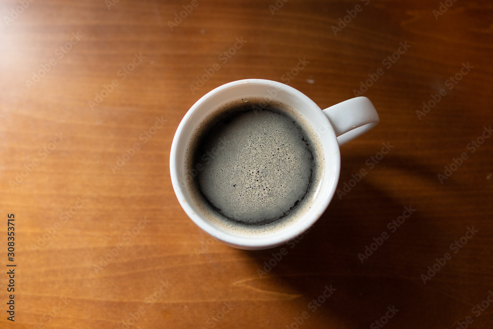 Cup of coffee on wooden table, top view Cup of coffee on wooden table, top view