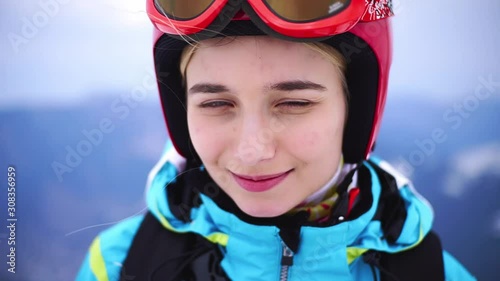 Wallpaper Mural Beautiful portrait face smiling young caucasian woman feel happy skier climbs the ski lift up the mountain winter and resting in the mountains resort close up slow motion Torontodigital.ca