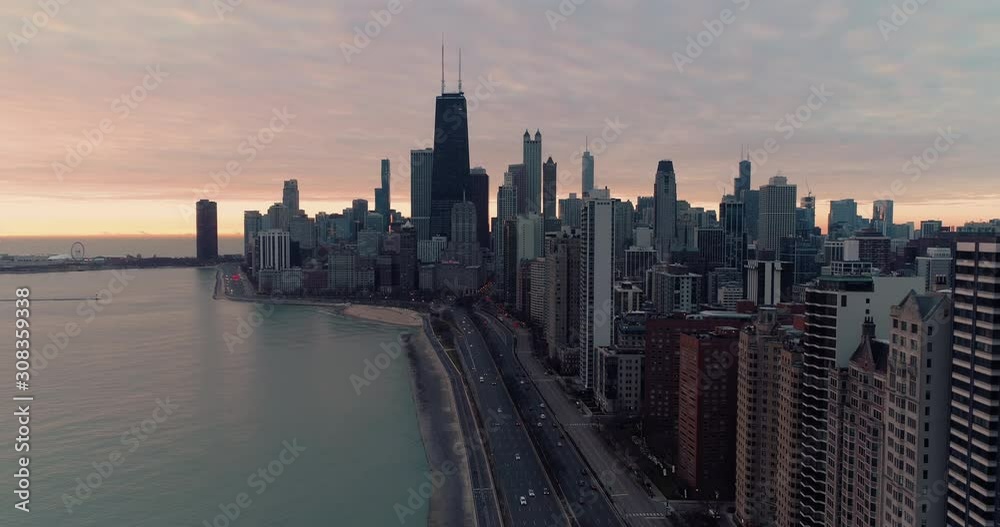Aerial view of Chicago Downtown skyline at sunrise. Road by the shore with cars