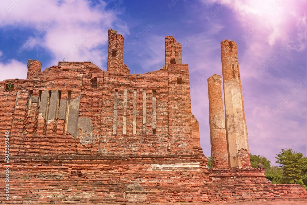 Old brick wall of temple in Ayutthaya Historical Park. Ancient bricks wall with sky cloud.