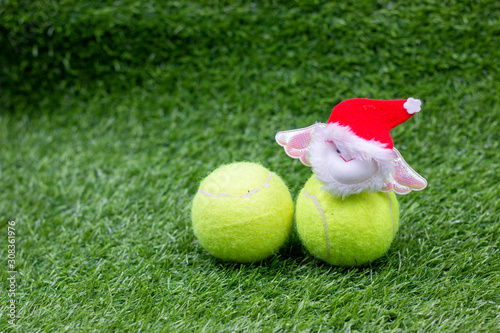Tennis Christmas Holiday with Santa Claus on green grass with tennis ball