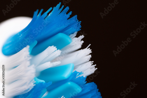 Blue white toothbrush bristles close up .