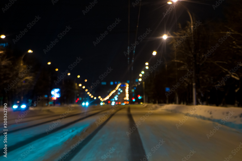 Deep track in the snow on the roadway of a city street.