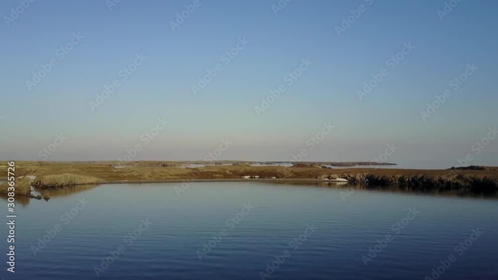 Coastline of Arctic Ocean in summer on desert Novaya Zemlya and lonely abandoned world of wildlife and nature of quiet north. Coastline of Arctic Ocean in summer on desert Novaya Zemlya and lonely abandoned world of wildlife and nature of quiet north.