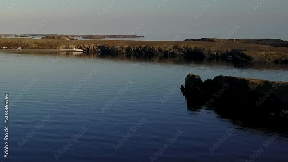 Coastline of Arctic Ocean in summer on desert Novaya Zemlya and lonely abandoned world of wildlife and nature of quiet north. Coastline of Arctic Ocean in summer on desert Novaya Zemlya and lonely abandoned world of wildlife and nature of quiet north.
