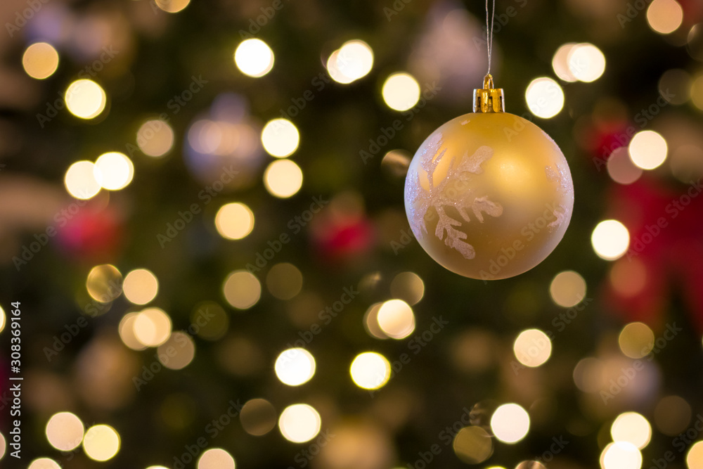 hand made ornament hangs in front of christmas background hand made ornament hangs in front of christmas background