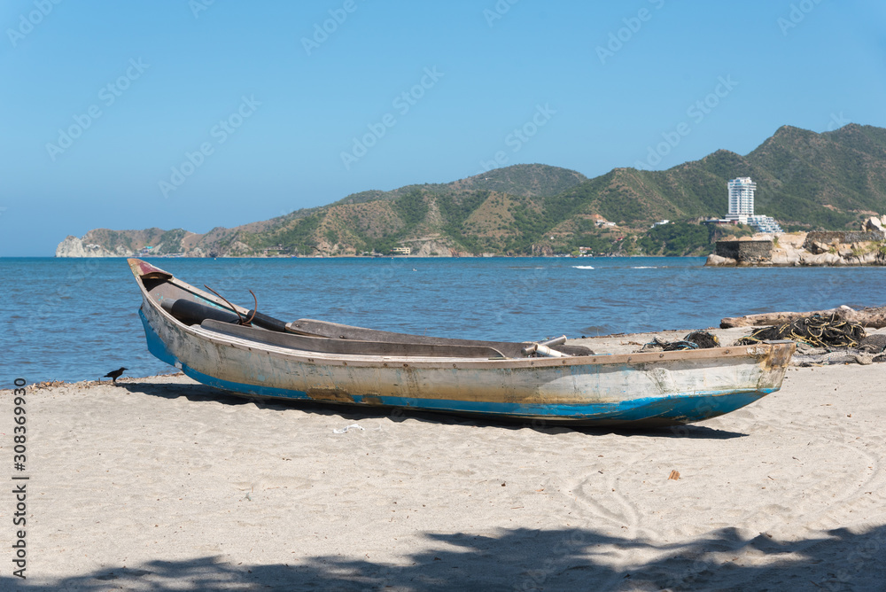 Fishing boat on the beach in the city of Santa Marta. Colombia