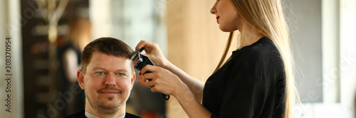 Woman Hairdresser Making Razor Haircut for Man