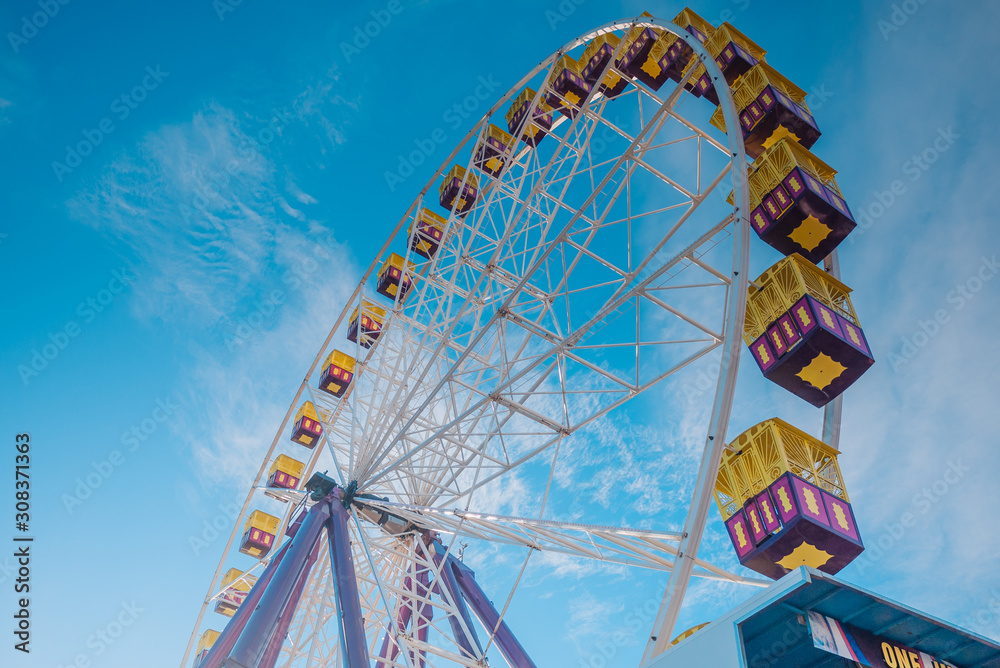 Ferris wheel running under blue sky