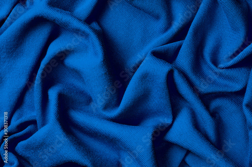Background of crumpled blue cotton fabric, trend color of year 2020 Classic Blue.