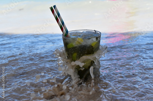 Glass of Mojito on the beach, tropical vacations background. photo