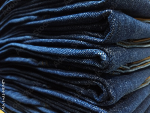 Close-up old Jeans trousers stack background texture.