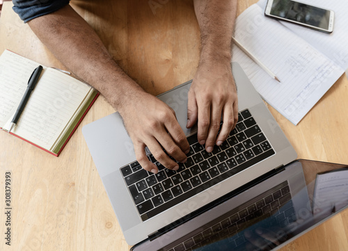 Male hands on laptop keyboard, shot from above. Technology Creativity Remote Work Freelancer Concept
