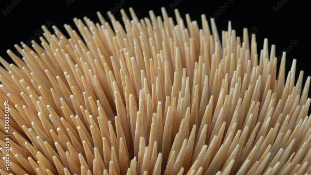 Toothpick on black background rotation. Cocktail stick or tooth pick macro focus to the centre. Concept of teeth hygiene or oral tooth care. Caries prevention. Dental healthcare. Toothpick on black background rotation. Cocktail stick or tooth pick macro focus to the centre. Concept of teeth hygiene or oral tooth care. Caries prevention. Dental healthcare.