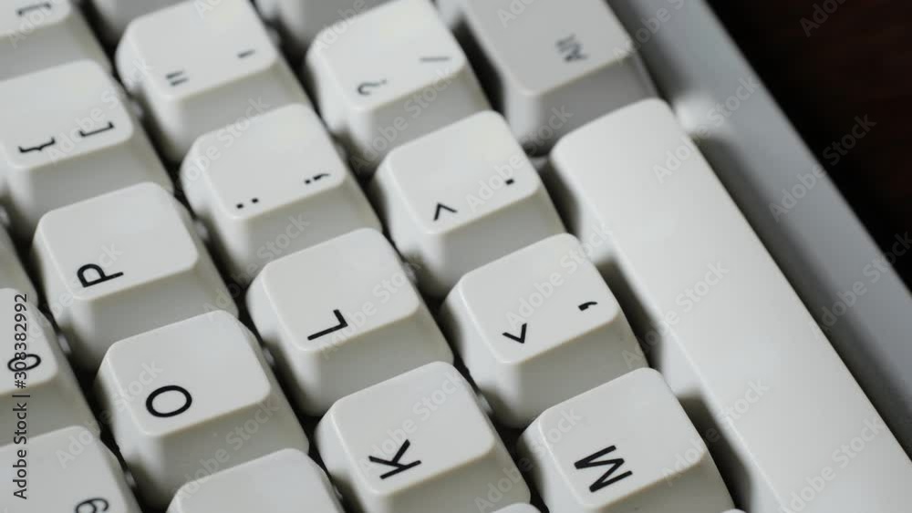 Finger presses comma or < button on keyboard Finger presses comma or < button on keyboard