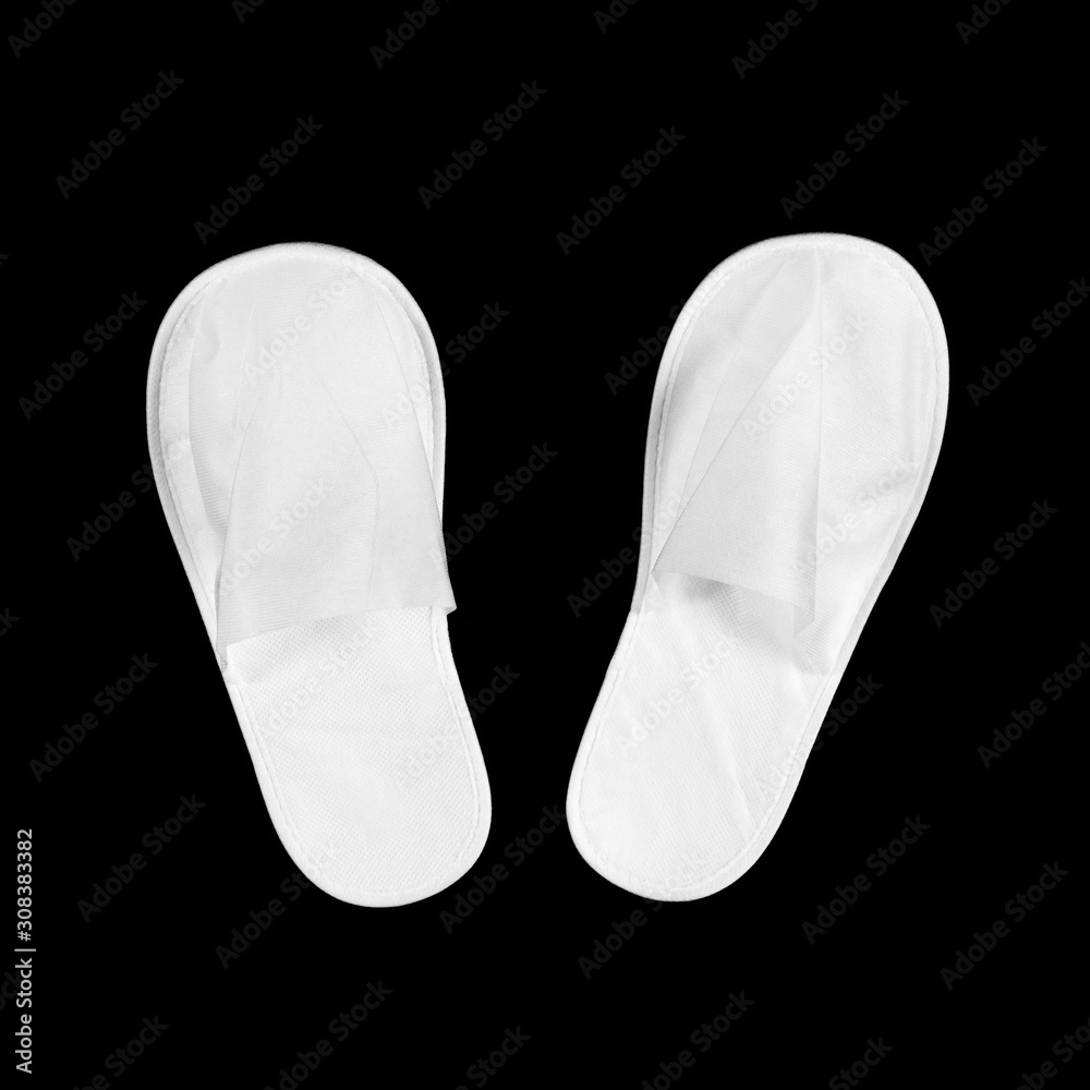 White house slippers. Isolated on black background. Close up White house slippers. Isolated on black background. Close up