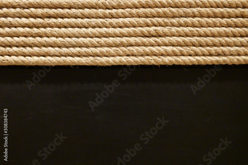 Dark brown wooden textured wallpaper with half light beige round rope roll braid detail vintage style for industrial concept
