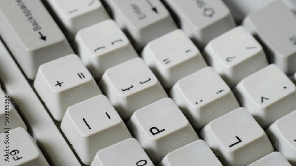Finger presses dash button on keyboard Finger presses dash button on keyboard