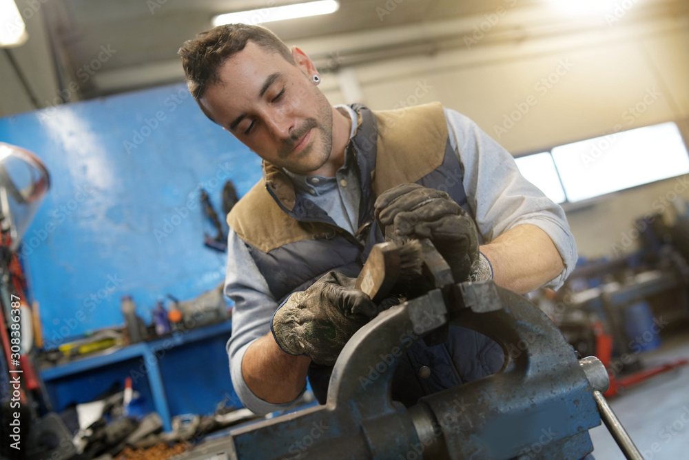 Mechanical employee working in workshop Mechanical employee working in workshop
