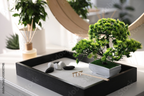 Beautiful miniature zen garden on white table indoors